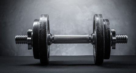 sports dumbbell on a dark background
