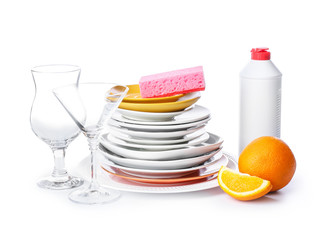 Clean tableware with sponge and detergent on white background