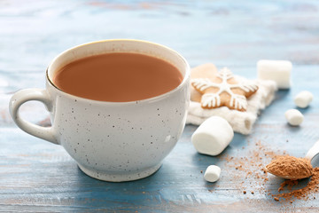 Cup of hot cocoa drink with marshmallows on table