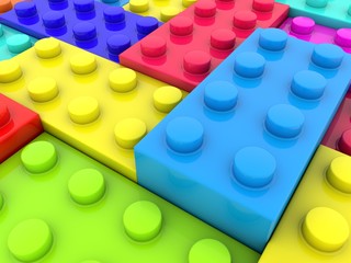 Colorful toy bricks of different heights in an abstract construction