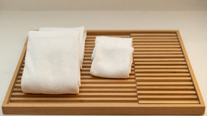 Face towels in a wooden battens tray.