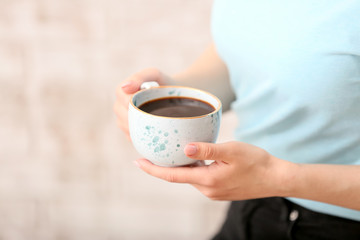 Woman with cup of hot coffee, closeup