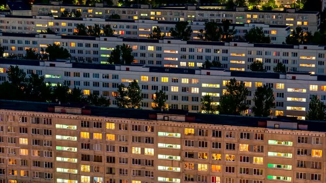 Timelapse of residential quarters of the night city with the lights on from the windows of the apartments.