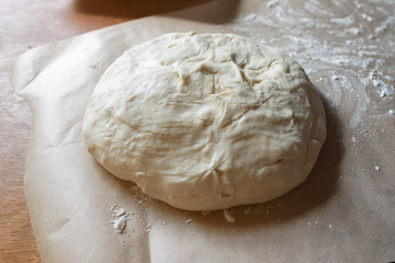 Flour dough for baking  on the kitchen table. Rustik style