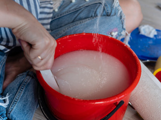 Laying laminate flooring in a room at home.