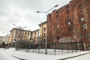The courtyard of an old apartment building in St. Petersburg with yellow shabby walls