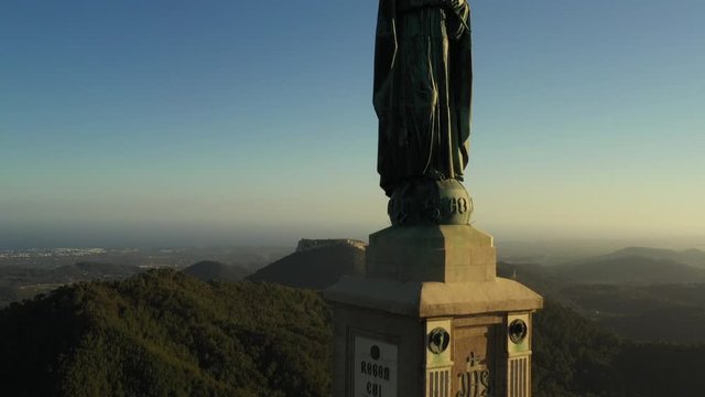 flying a drone over the monastery and statue of Christ sanctuary of San Salvador Majorca Spain