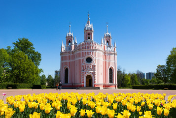 Orthodox Church, yellow tulips against the blue sky on a Sunny day