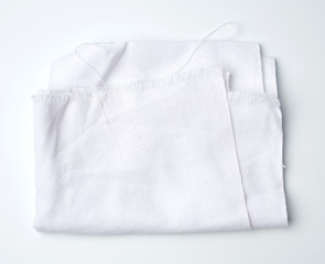 folded cotton white cotton fabric on a white background,