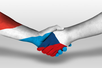 Handshake between czech republic and luxembourg flags painted on hands, illustration with clipping path.