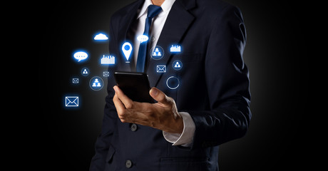 Close up hand of business Man using a smartphone. That shows analysis of sales data and graphs for economic growth graphs Business strategy.Technology concept,Mixed media