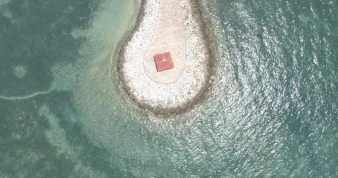 Overhead drone shot of man-made land strip on coral reef