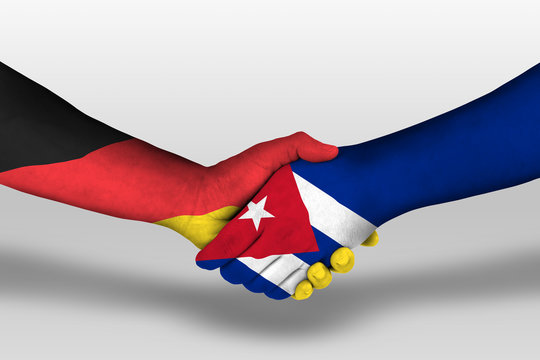 Handshake between cuba and germany flags painted on hands, illustration with clipping path.