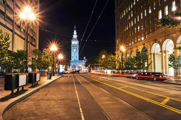 Naklejka na ściany i meble Looking down Market Street to the Ferry Building in San Francisco with long exposure