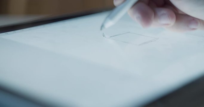 Digital Drawing Box. An artist sketches, then erases and starts over on a digital drawing tablet.