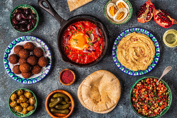 Fototapeta na wymiar Falafel, hummus, shakshuka, Israeli salad - traditional dishes of Israeli cuisine.