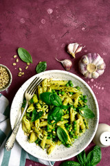 Penne pasta with green pea and basil pesto. Top view with copy space.