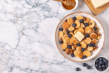 Trendy breakfast with mini pancakes, blueberries and chocolate chips.
