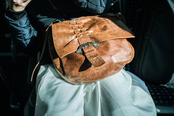 Leather bag on woman knee