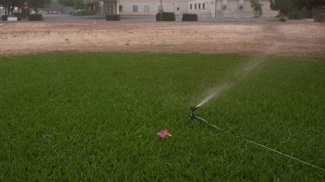 Vacaville, California, USA. 22 August 2020.  Aerial:  grass sprinkler going during wildfire. LNU Lightning Complex Fire that ravaged the Napa, Sonoma, Lake and Solano counties.
