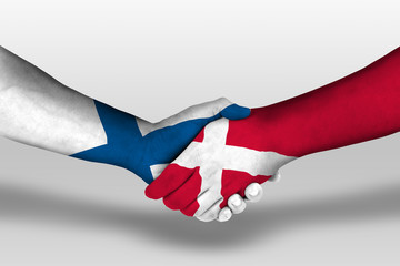 Handshake between denmark and finland flags painted on hands, illustration with clipping path.