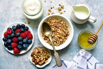 Healthy breakfast : granola, nuts, honey, fresh berries and dairy products. Top view with copy space.