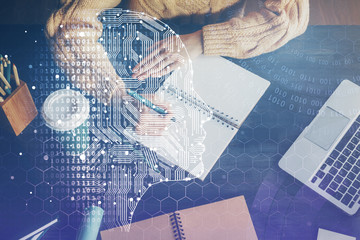 Multi exposure of writing hand on background with brain hologram. Concept of learning.