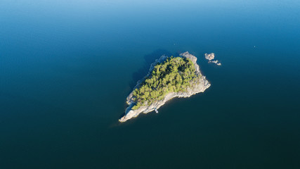 Landscape of the Baltic Sea with an island and a boat. Aerial view.