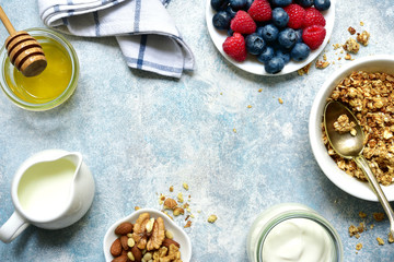 Healthy breakfast : granola, nuts, honey, fresh berries and dairy products. Top view with copy space.