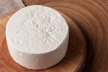 Fresh round cheese, typical of the interior of Brazil in the state of Minas Gerais - Minas frescal. Top view. Copy space.