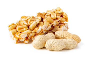 Peanut Brittle bars (Indian Peanut Chikki) with groundnut isolated on white background.