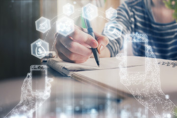 Tech theme hologram over woman's hands taking notes background. Concept of hightech. Double exposure