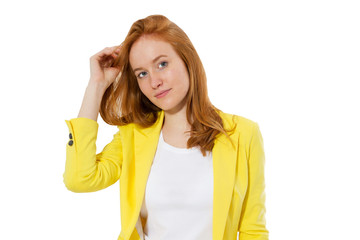 Obraz na płótnie Canvas Beautiful young redhead woman on white background. Happy beautiful young red head woman in a stylish yellow jacket copy space. Attractive red hair girl looking at camera.