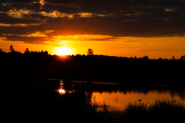 orange sunset over the river. sunset over the river. beautiful warm summer red sunset