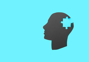 Human head with lost puzzle piece on color background. Concept of neurology