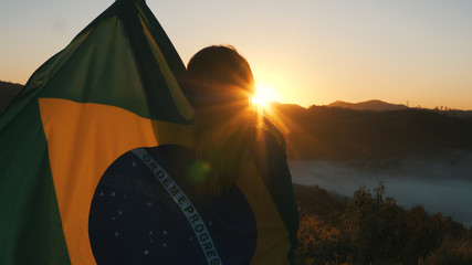 Brazilian Girl with National Flag at sunrise
