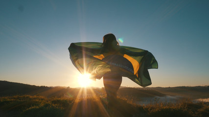 Brazilian Girl with National Flag at sunrise