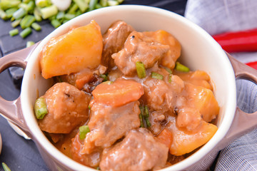 Tasty beef stew in pot, closeup