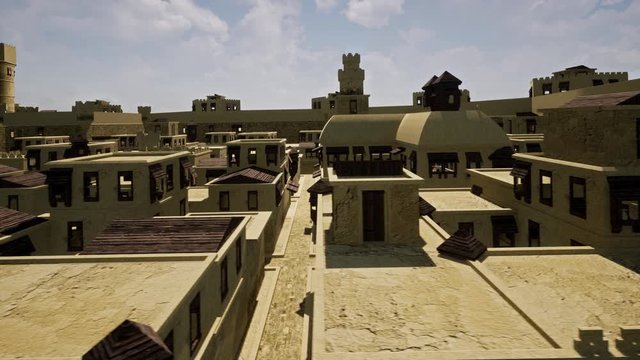 The old and abandoned sandstone architecture of a Persian city surrounded by its defensive wall which was built as fortification to protect the city from the outside.