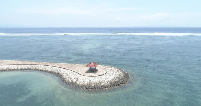 Drone pan and orbit of man-made land  strip on the coral reef