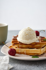 Baked traditional Belgium waffles with ice cream and cherries. Breakfast.