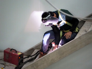 Welding work ,worker with protective welding metal on construction