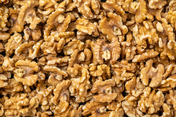 shelled English walnuts background - superfood concept