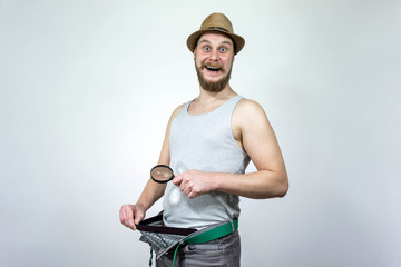 Man looking in his underwear with magnifying glass