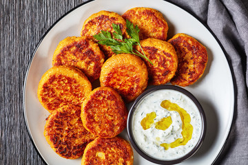 Butternut squash fritters with tzatziki on a plate