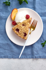 Raspberry and crumble pie. Fresh dessert fruit tart covered in raspberries.