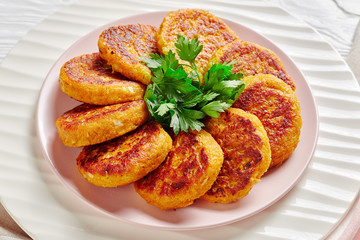 Curried vegan butternut squash fritters on a plate