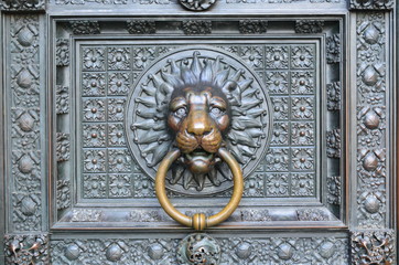 Bronze knocker in the shape of a lion head from the gate of the Cologne Cathedral, Germany
