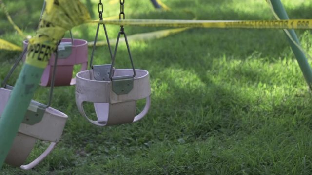 Slomo static shot of closed swing set due to pandemic