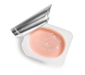 Plastic cup of strawberry yogurt on white background